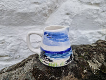 Load image into Gallery viewer, A small jug with the sea and beach painted on it