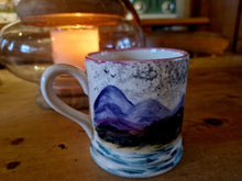 Load image into Gallery viewer, Ceramic mug with mountain design on a wooden surface
