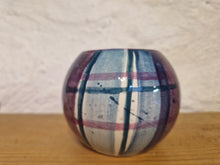 Load image into Gallery viewer, A cylindrical tealight holder on a wooden bench with a wall behind it
