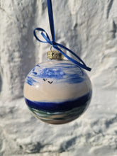 Load image into Gallery viewer, Decorative ornament with blue and white design on a marble surface
