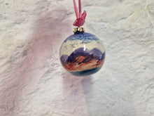 Load image into Gallery viewer, Decorative ornament with mountain landscape design on a textured white background
