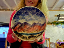 Load image into Gallery viewer, A lady holding a bowl with the hills and sea painted on it.
