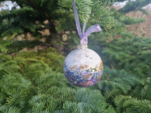 Load image into Gallery viewer, A speckled purple and pink bauble hanging on a Christmas tree by a ribbon.
